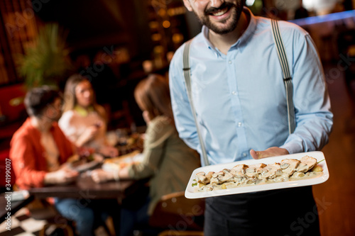 Waiter carrying plate with ...