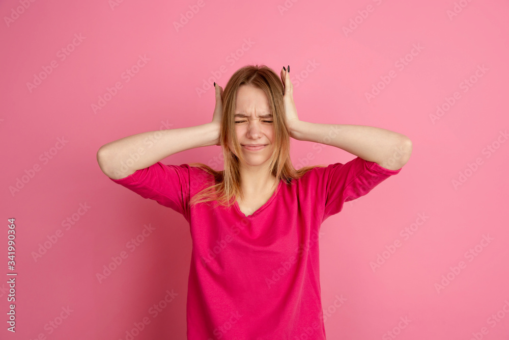 Crazy shocked, upset. Caucasian young woman's portrait isolated on pink studio background, monochrome. Beautiful female model. Concept of human emotions, facial expression, sales, ad, trendy. Crazy shocked, upset. Caucasian young woman's portrait isolated on pink studio background, monochrome. Beautiful female model. Concept of human emotions, facial expression, sales, ad, trendy.