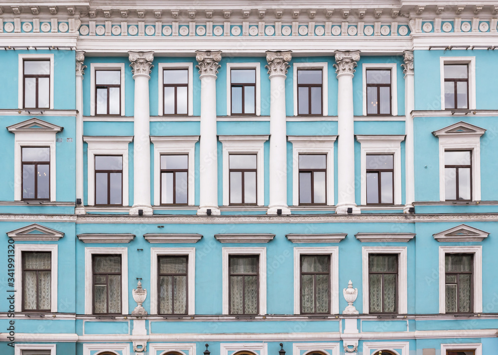 Fototapeta premium Vintage architecture classical light blue facade with columns, vases and meander. Front view.