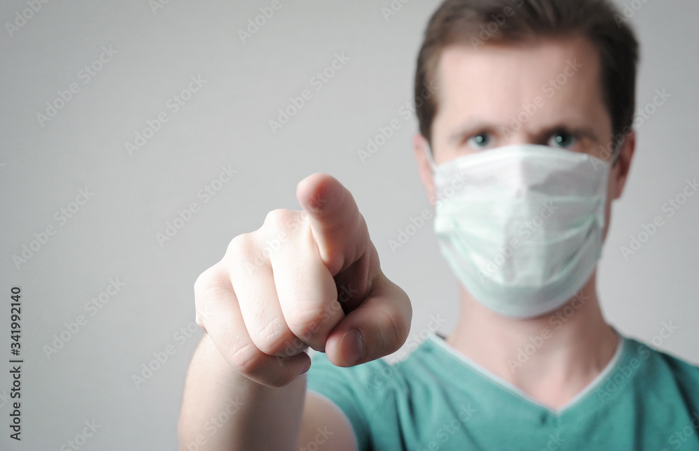 man in medical mask points a finger at you, you are next concept man in medical mask points a finger at you, you are next concept
