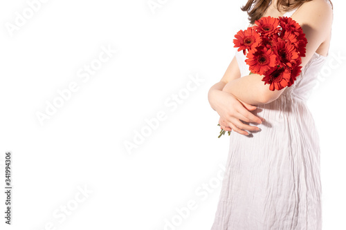 Fototapeta Naklejka Na Ścianę i Meble -  young girl holding a bouquet of gerbera flowers