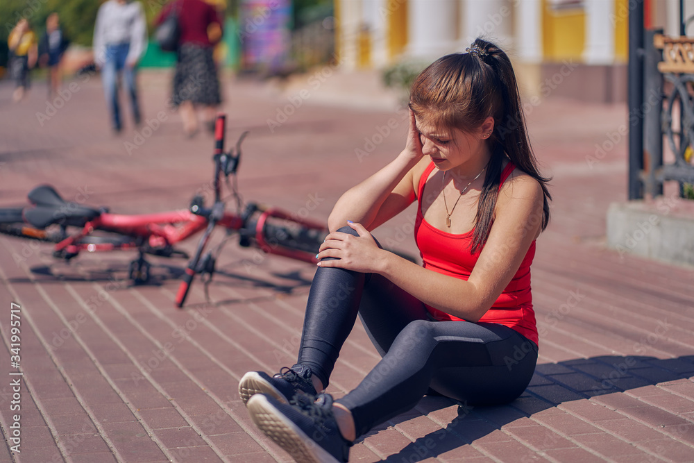 teen girl fallen off her bicycle outdoors