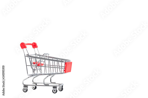 A Shopping Cart. Mini shopping trolley, isolated on white background. Mini Shopping Cart On The Table. Business , e-commerce concept. © kanpisut