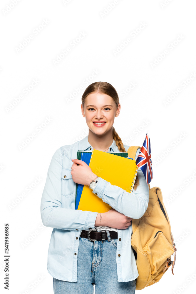 smiling girl with backpack holding copybooks and uk flag isolated on white smiling girl with backpack holding copybooks and uk flag isolated on white