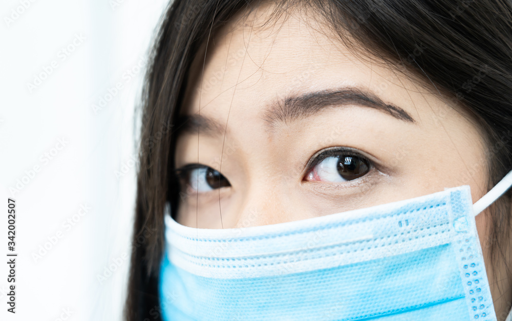 Close up woman with headache wearing mask for protect Covid-19 Close up woman with headache wearing mask for protect Covid-19