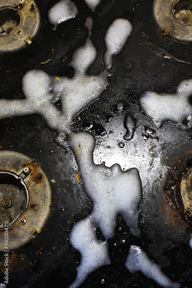 Old dirty gas stove/oven with ugly sticky residue on black glass