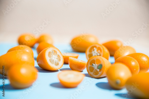Chinese oranges on bamboo table and blue background.