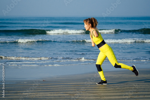 happy asian armless woman warming up before swimming at the tropical beach photo