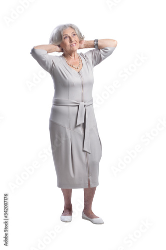 Happy senior woman wearing light dress isolated