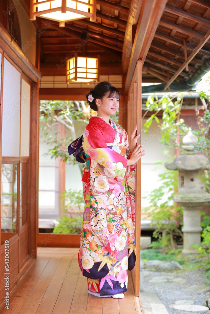 Attractive girl wearing traditional japanese kimono in Japanese-style garden in kyoto, Japan. Attractive girl wearing traditional japanese kimono in Japanese-style garden in kyoto, Japan.