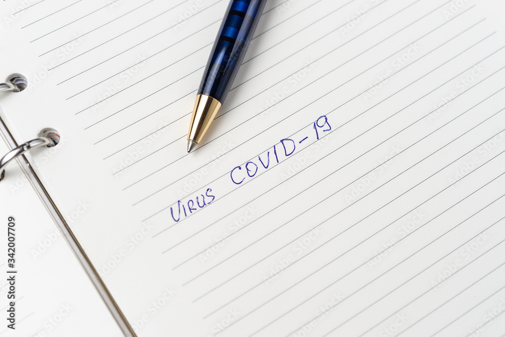 Coronavirus Covid-19 text written on empty sheet in a daily planner. Coronavirus Covid-19 text written on empty sheet in a daily planner.