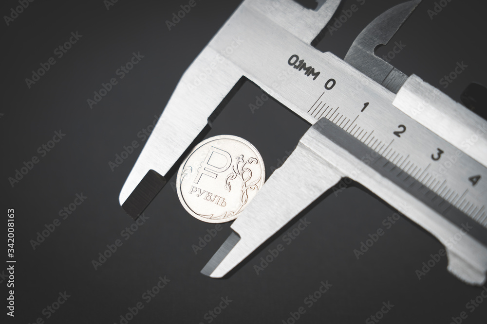 coins in a caliper, business concept coins in a caliper, business concept