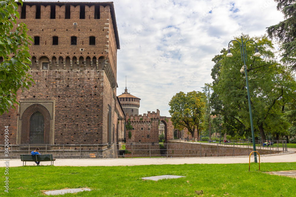 Fragment of the fortress wall, the moat and corner tower of the Sforzesco Castle in Milan, Italy Fragment of the fortress wall, the moat and corner tower of the Sforzesco Castle in Milan, Italy