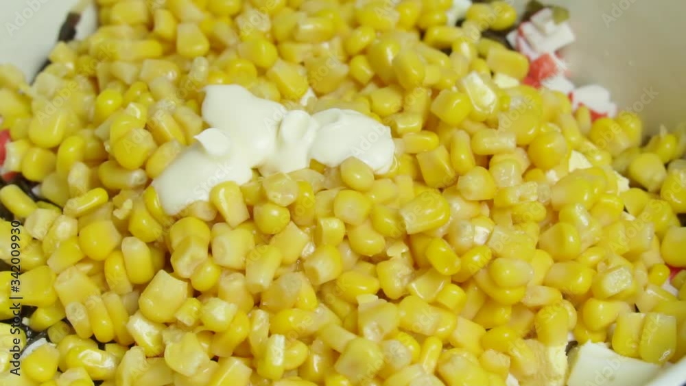 making corn salad, add mayonnaise in slow motion. making corn salad, add mayonnaise in slow motion.