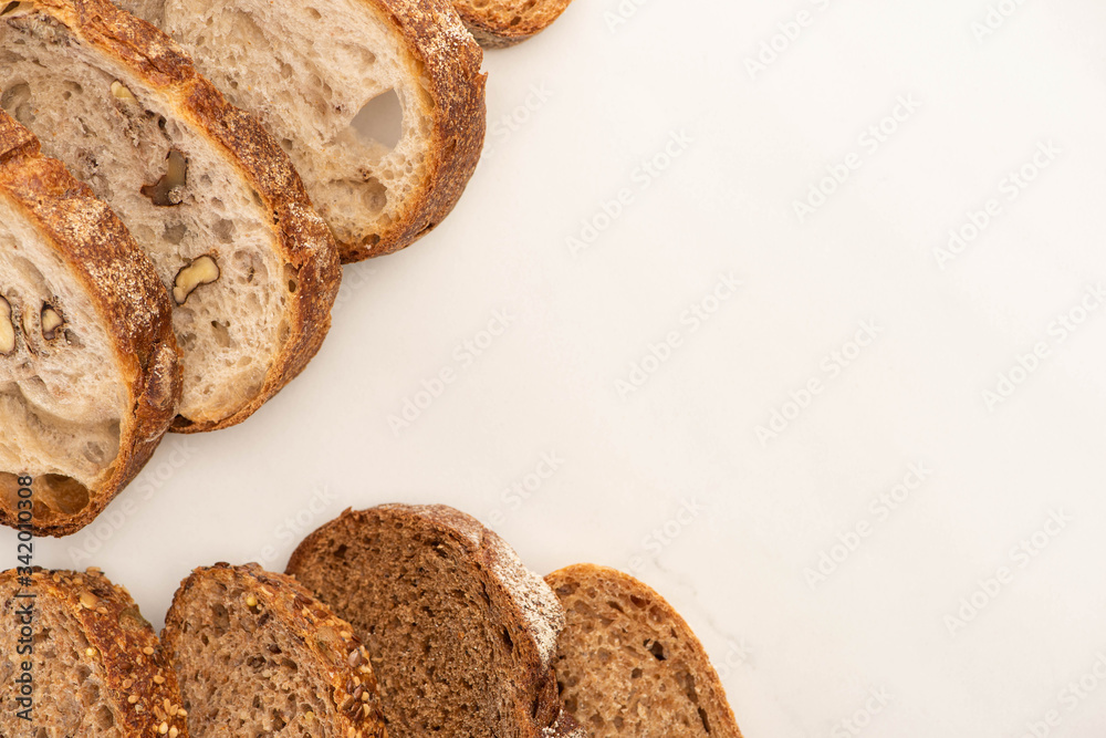 top view of whole wheat bread slices on white background with copy space