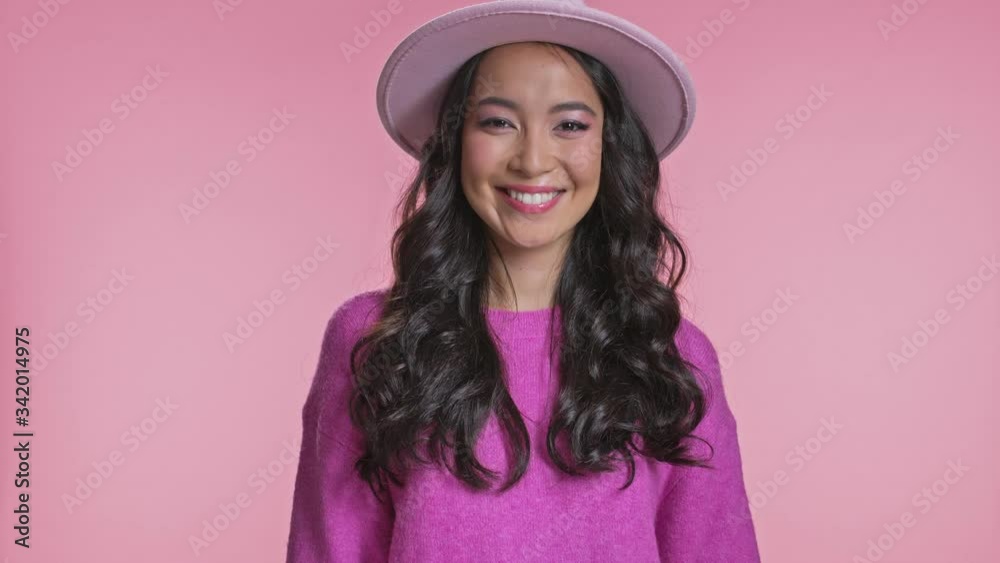 Amazing cute happy young asian woman posing isolated over pink wall background blowing kisses. Amazing cute happy young asian woman posing isolated over pink wall background blowing kisses.