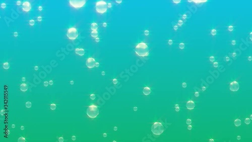 Lots of sparkling blurred bubbles racing to the surface of a liquid fizzy carbonated drink