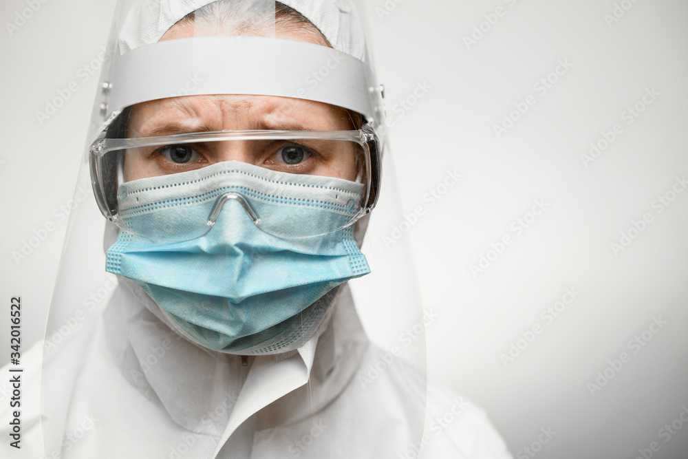 female doctor in protective suit with shield and medical mask.