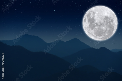 Full moon on the sky over the mountains.