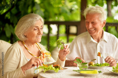 Portrait of happy senior couple having diner