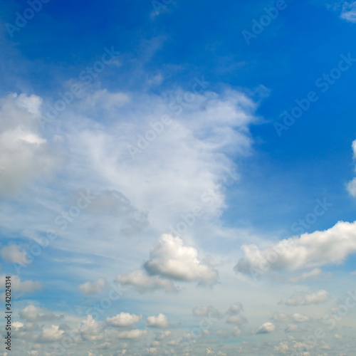Cumulus clouds in the blue sky .