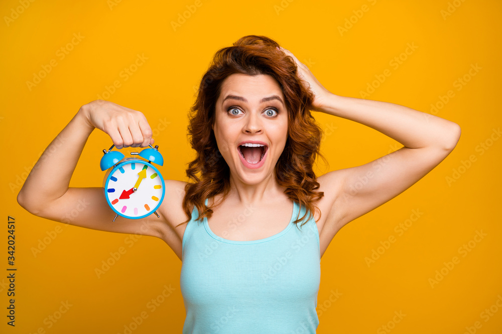 Close-up portrait of her she nice attractive crazy overjoyed cheerful cheery wavy-haired girl holding in hand ring clock early wake up isolated on bright vivid shine vibrant yellow color background Close-up portrait of her she nice attractive crazy overjoyed cheerful cheery wavy-haired girl holding in hand ring clock early wake up isolated on bright vivid shine vibrant yellow color background