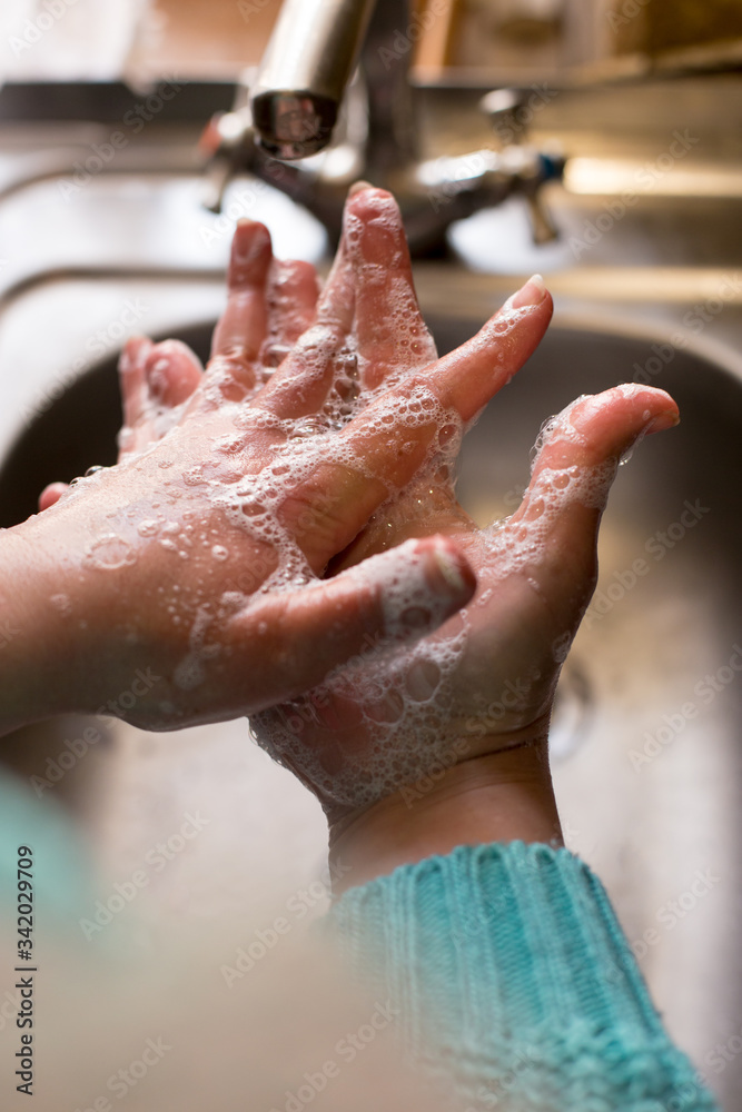 Fototapeta premium Woman washing hands. Wash hands with soap.