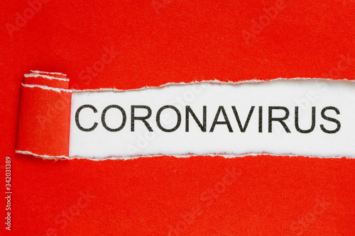 Top view of red torn paper and the text CORONAVIRUS