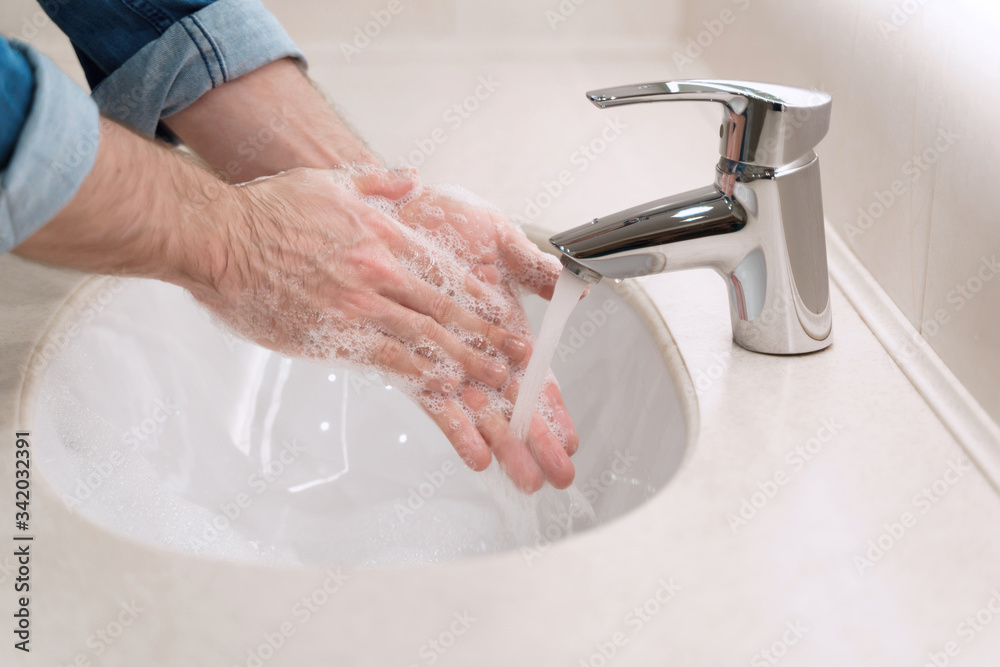 Proper washing and handling hands rubbing palms with soap for coronavirus prevention, hygiene to stop spreading COVID-19. Liquid antibacterial soap Proper washing and handling hands rubbing palms with soap for coronavirus prevention, hygiene to stop spreading COVID-19. Liquid antibacterial soap