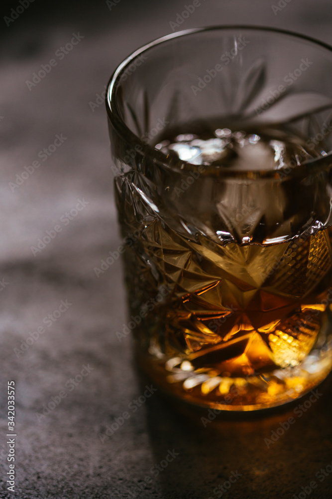 old fashioned whiskey bourbon cocktail on wooden background