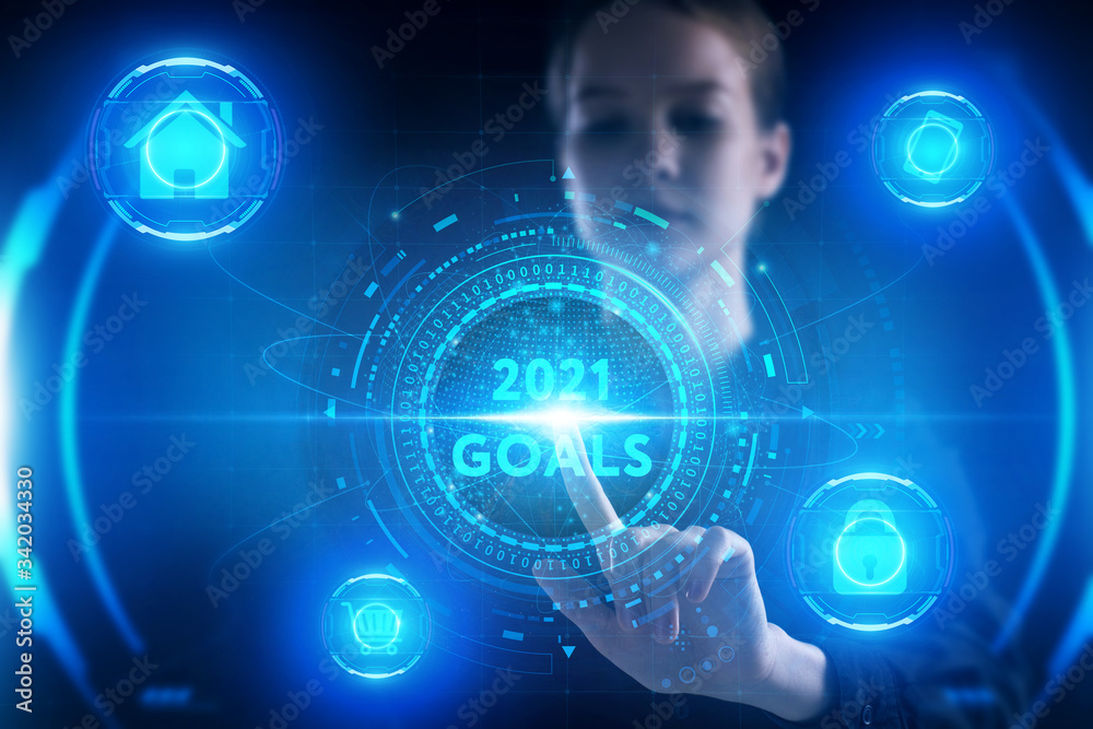 Business, Technology, Internet and network concept. Young businessman working on a virtual screen of the future and sees the inscription: 2021 goals Business, Technology, Internet and network concept. Young businessman working on a virtual screen of the future and sees the inscription: 2021 goals