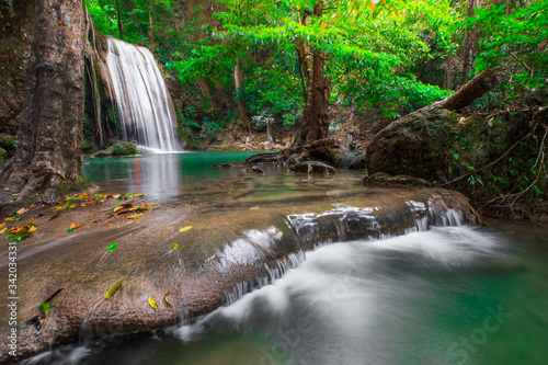 Hot Springs Onsen Natural Bath ,Waterfalls and fish swim in the emerald blue water in Erawan National Park. Erawan Waterfall is a beautiful natural rock waterfall in Kanchanaburi,Thailand.