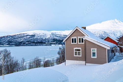 Frozen lake with snowy mountains during winter in Lapland. 