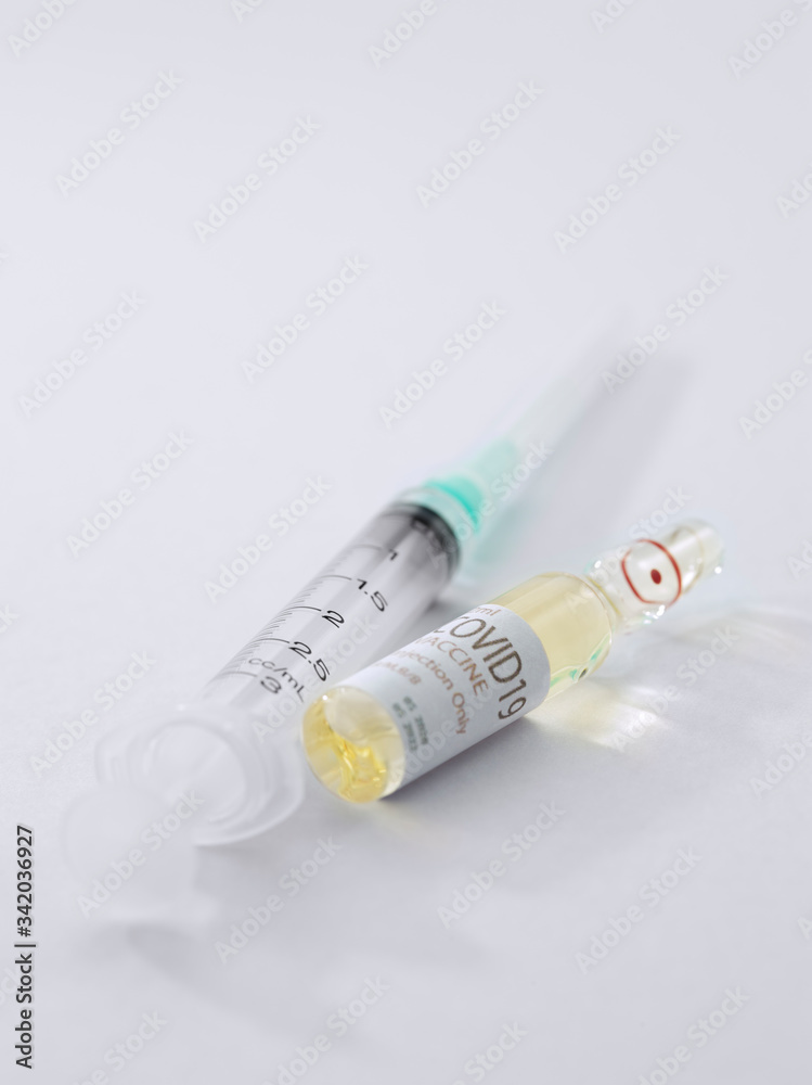 Close up view of the ampule with medicine and syringe on white back 