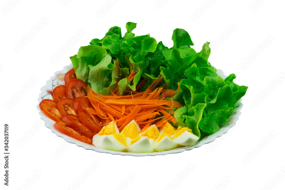 Lettuce, carrots, tomatoes and boiled eggs on the plate with clipping path