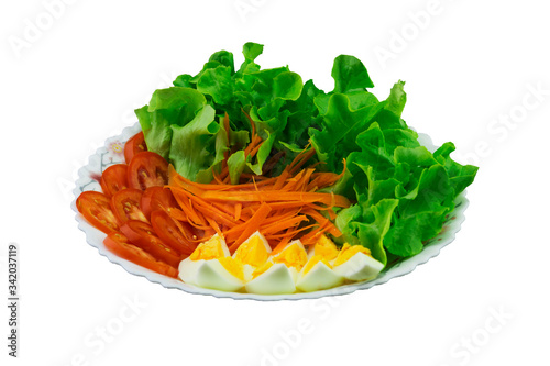 Obraz na płótnie Lettuce, carrots, tomatoes and boiled eggs on the plate with clipping path w salonie