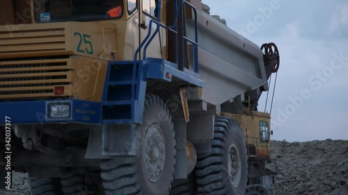 Heavy Mining Dump Truck Being Loaded With Iron Ore in pit