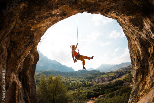 Fotobehang Rock climber hanging on a rope,