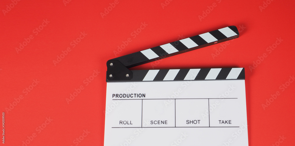 Obraz premium Clapperboard or movie slate. it use in video production ,film, cinema industry on red background.