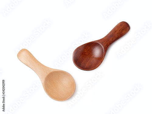 Wooden spoons with a shadow on a white background.
