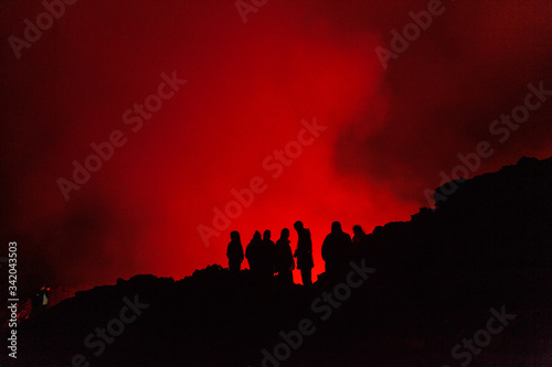 People watching lava glowing inside the Nyiragongo volcano in Congo