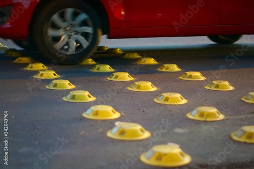 Wallpaper Mural Yellow reflective road studs on a city street, used as a traffic calming measure. Torontodigital.ca