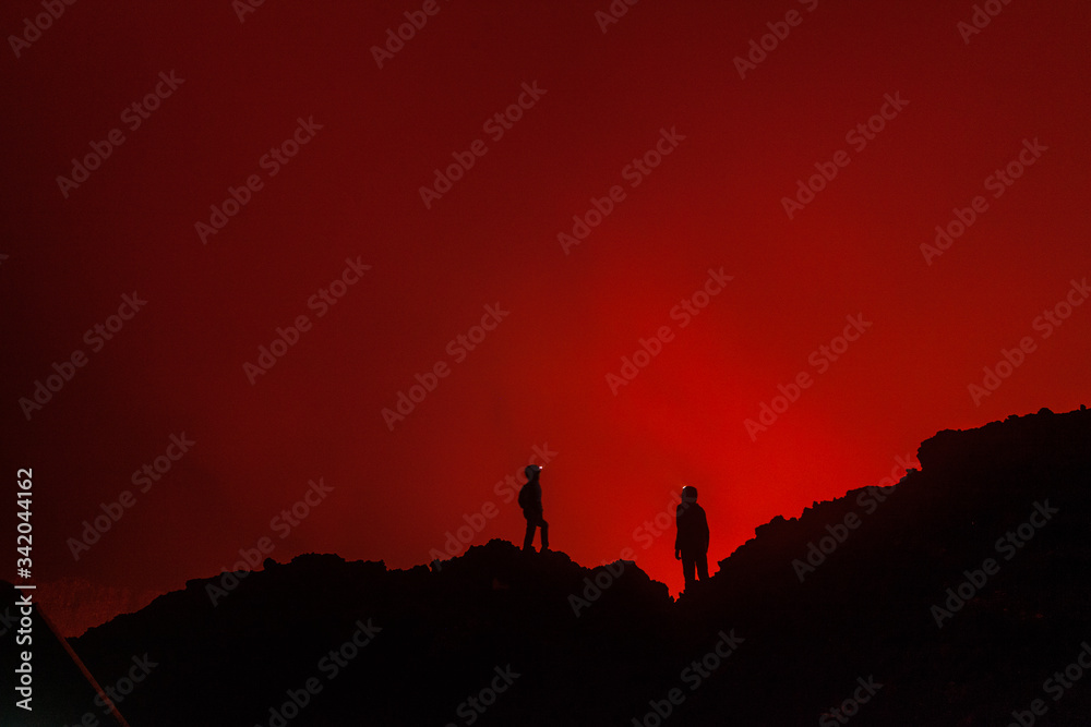 Tourists at the edge of volcano crater in Congo Tourists at the edge of volcano crater in Congo