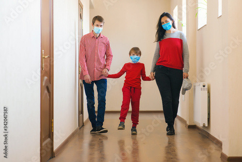 Family wearing safety medical masks. Coronavirus epidemic. Health care concept. © volurol