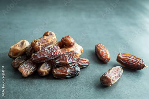 Raw date fruit ready to eat on concrete background. Traditional, delicious and healthy ramadan food.