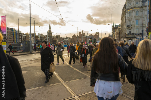 Photography Crowd of people walking on the street in front of Amsterdam Central station at t