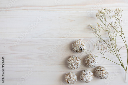 energy ball using honey, oats, raisins, banana and oatmeal, homemade food without baking and sugar free, vegan snacks on a light wooden background