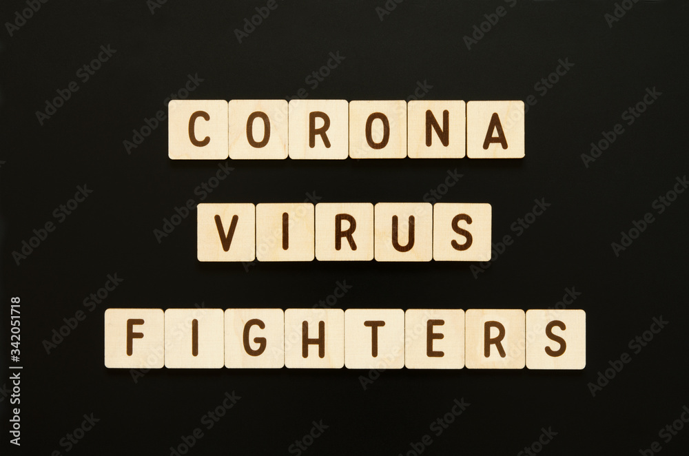 CORONAVIRUS FIGHTERS - words from wooden blocks with letters. Top view on gray background. - Image CORONAVIRUS FIGHTERS - words from wooden blocks with letters. Top view on gray background. - Image