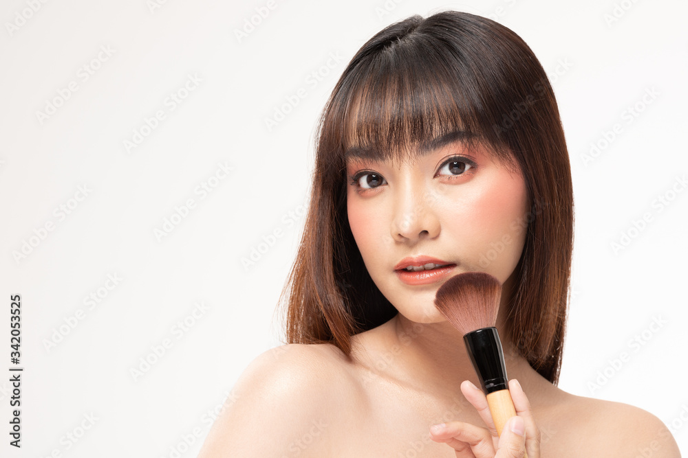 Beauty asian woman brown hair looking smile in camera happiness and hold make up brush and cheerful with make up brush,Beauty Concept on white background. Beauty asian woman brown hair looking smile in camera happiness and hold make up brush and cheerful with make up brush,Beauty Concept on white background.
