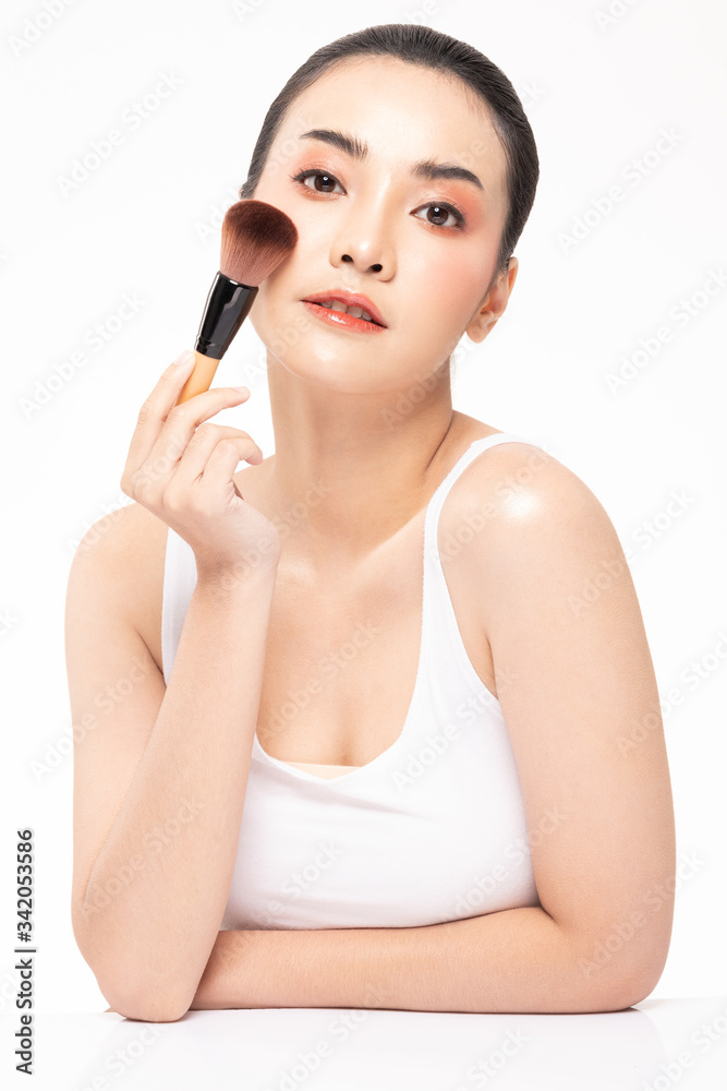 Beauty asian woman brown hair looking smile in camera happiness and hold make up brush and cheerful with make up brush,Beauty Concept on white background. Beauty asian woman brown hair looking smile in camera happiness and hold make up brush and cheerful with make up brush,Beauty Concept on white background.